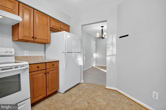 a kitchen with stainless steel appliances granite countertop a refrigerator sink and cabinets