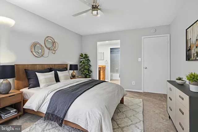 a bedroom with a bed and large windows