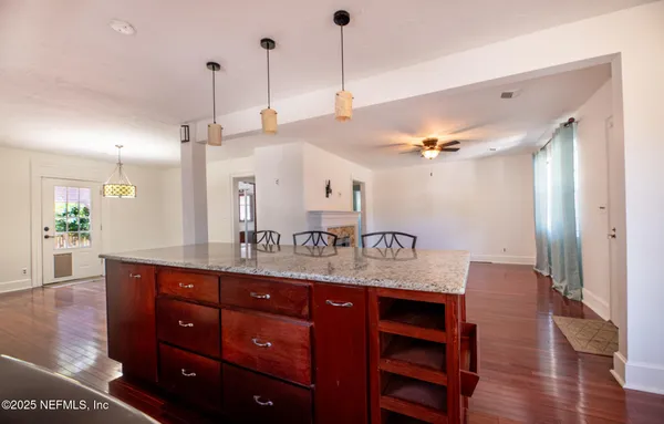 a room with lots of wooden furniture and shower