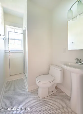 a white toilet sitting next to a bathroom sink