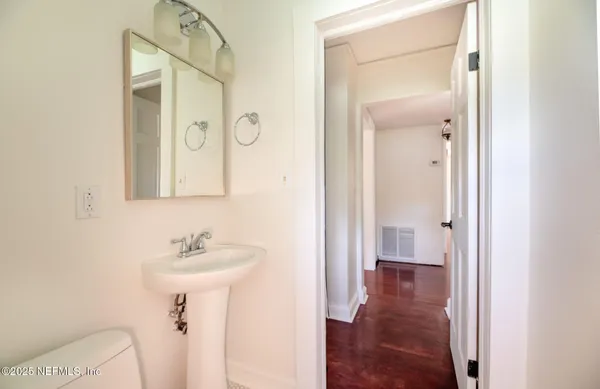 a bathroom with a sink mirror and vanity