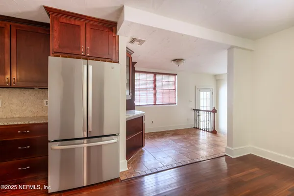 a white refrigerator freezer and a stove sitting inside of a kitchen
