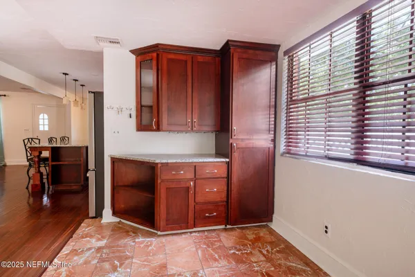 a view of kitchen with furniture and a window