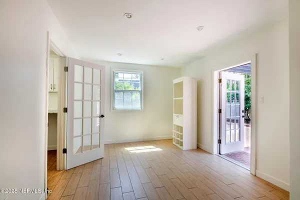 a view of an empty room with closet and a window