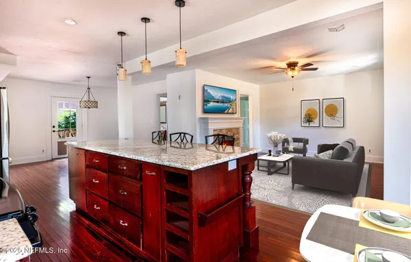 a view of living room with kitchen island furniture and a chandelier