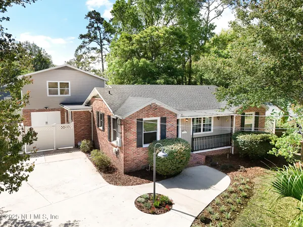 an aerial view of a house with yard and garage