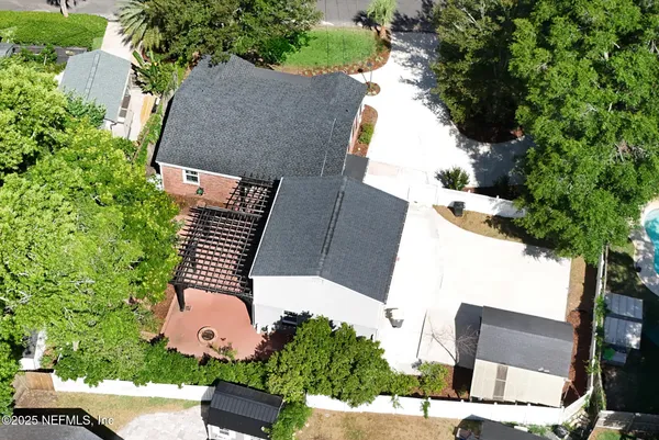 a front view of house with yard and trees around