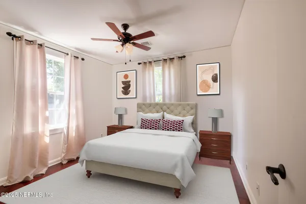a bedroom with a large bed and a window