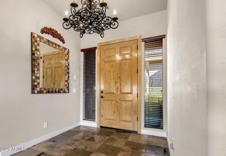 a living room with large window and furniture