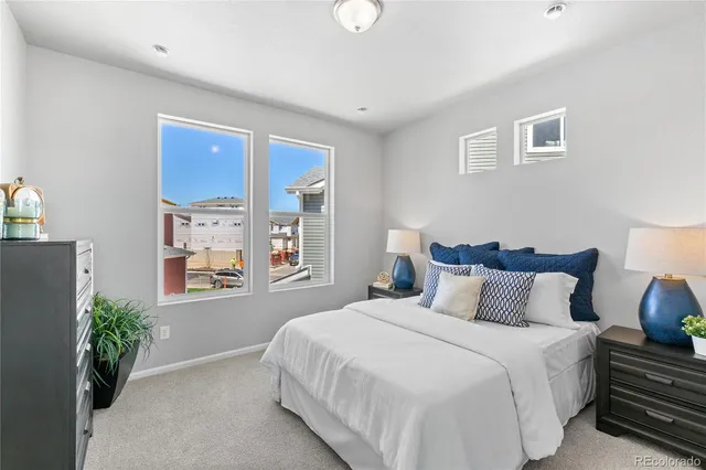 a bedroom with bed and windows