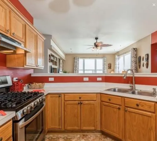 a kitchen with granite countertop a sink stainless steel appliances and cabinets