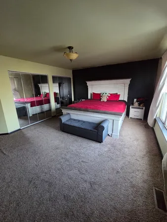 a bathroom with a granite countertop sink mirror and bathtub