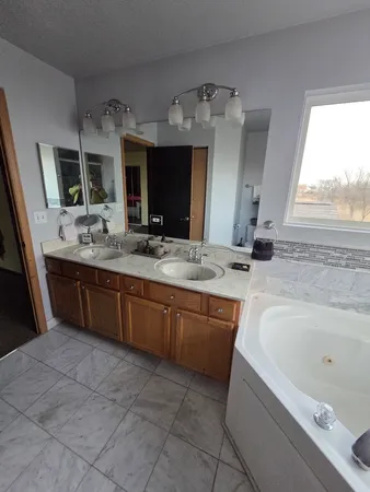 a bathroom with a sink a vanity and a bathtub