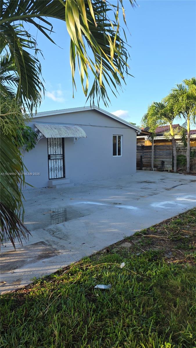3300 Northwest 23rd Avenue, Unit 1 Miami, FL 33142 - Photo 2 of 11 a front view of a house with a yard