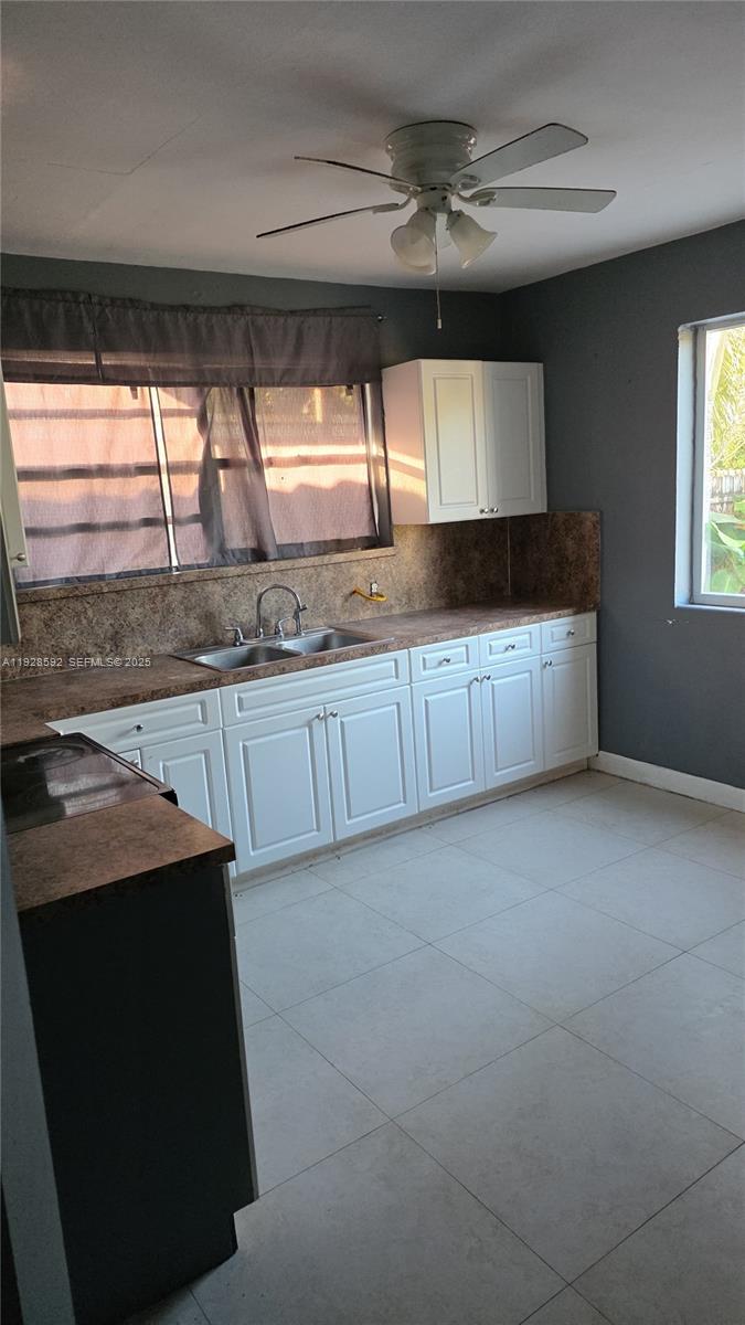 3300 Northwest 23rd Avenue, Unit 1 Miami, FL 33142 - Photo 3 of 11 a kitchen with stainless steel appliances granite countertop a sink and a stove