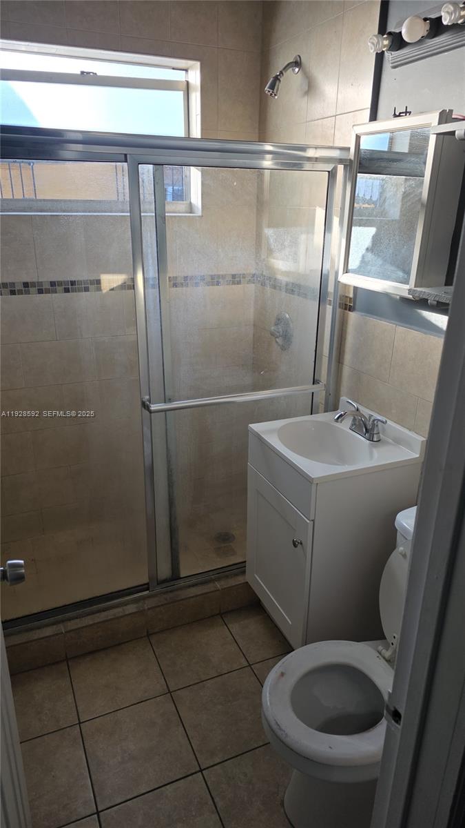 3300 Northwest 23rd Avenue, Unit 1 Miami, FL 33142 - Photo 8 of 11 a white toilet sitting next to a shower