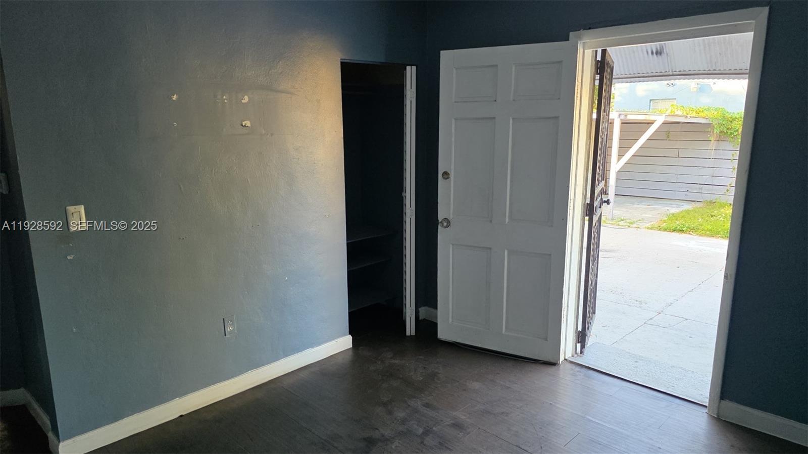 3300 Northwest 23rd Avenue, Unit 1 Miami, FL 33142 - Photo 10 of 11 an empty room with wooden floor and a window