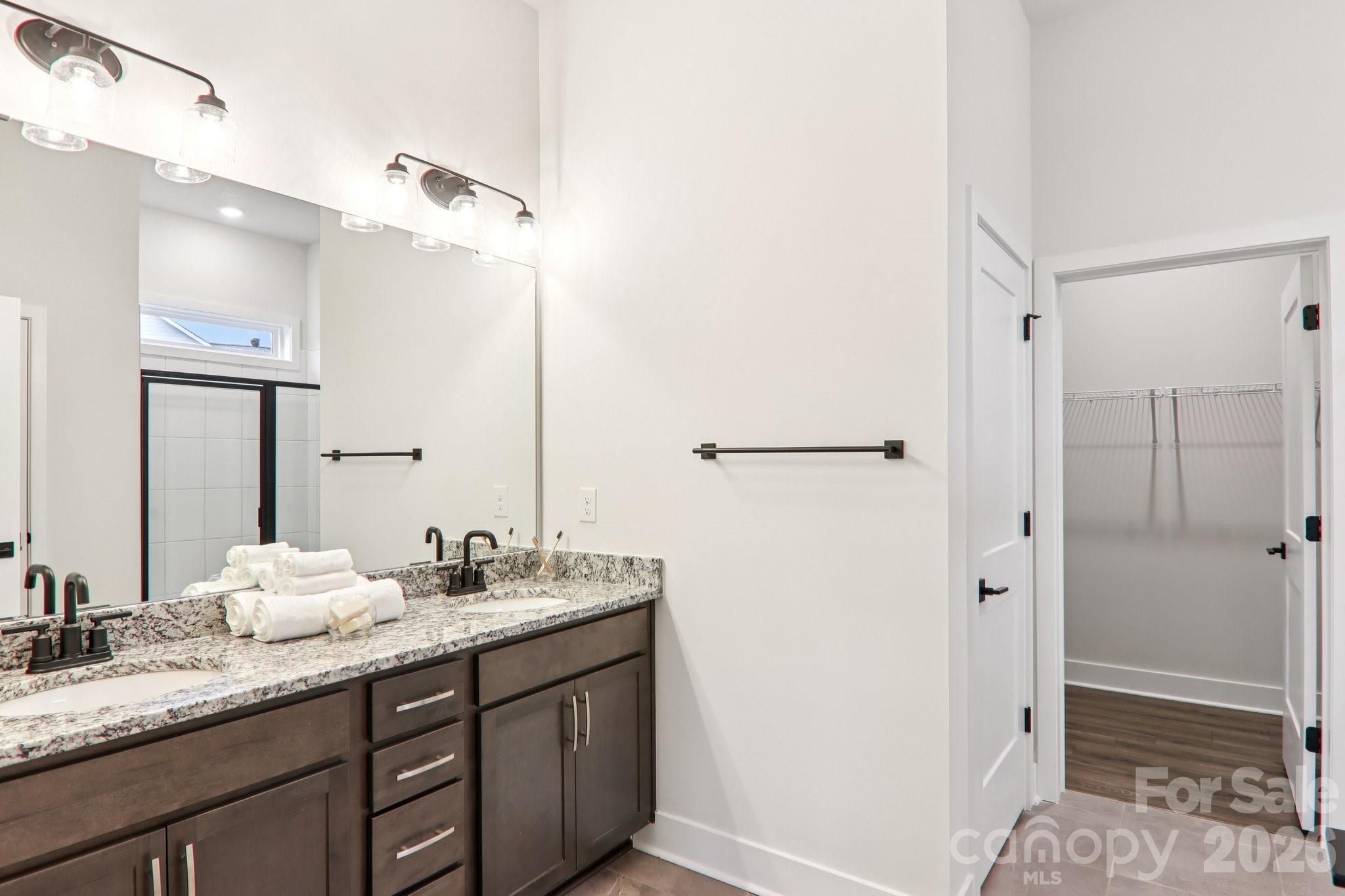 201 Piney Wds Road Fletcher, NC 28732 - Photo 29 of 47 a bathroom with a granite countertop sink mirror and double