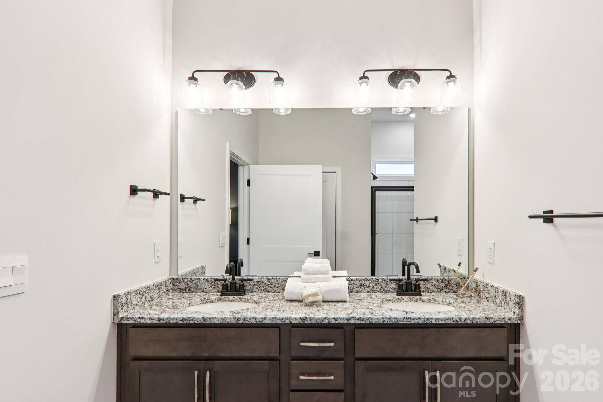 201 Piney Wds Road Fletcher, NC 28732 - Photo 30 of 47 a bathroom with a granite countertop sink and a mirror