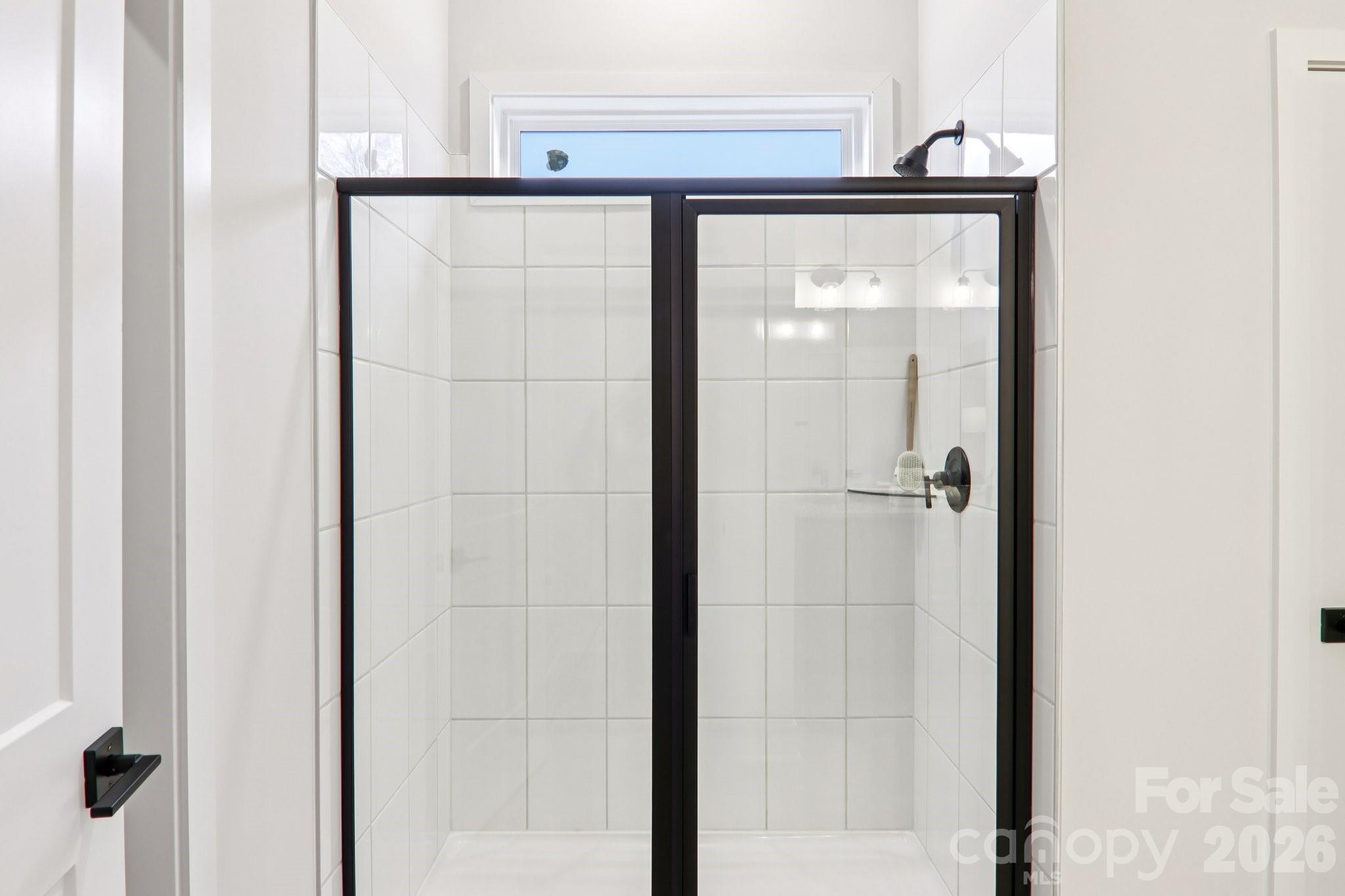 201 Piney Wds Road Fletcher, NC 28732 - Photo 31 of 47 a bathroom with a glass shower door