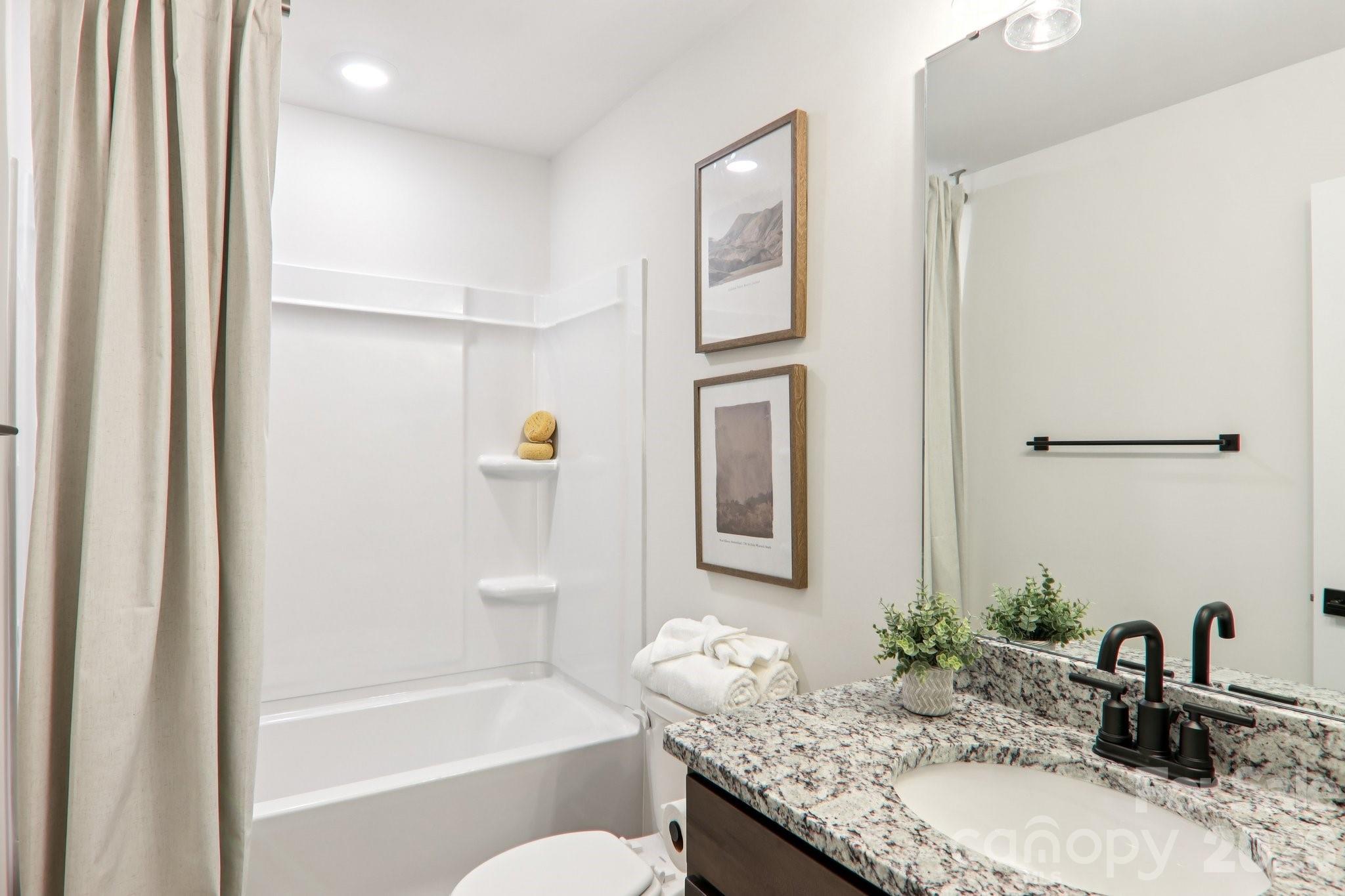 201 Piney Wds Road Fletcher, NC 28732 - Photo 44 of 47 a bathroom with a granite countertop sink tub and a mirror