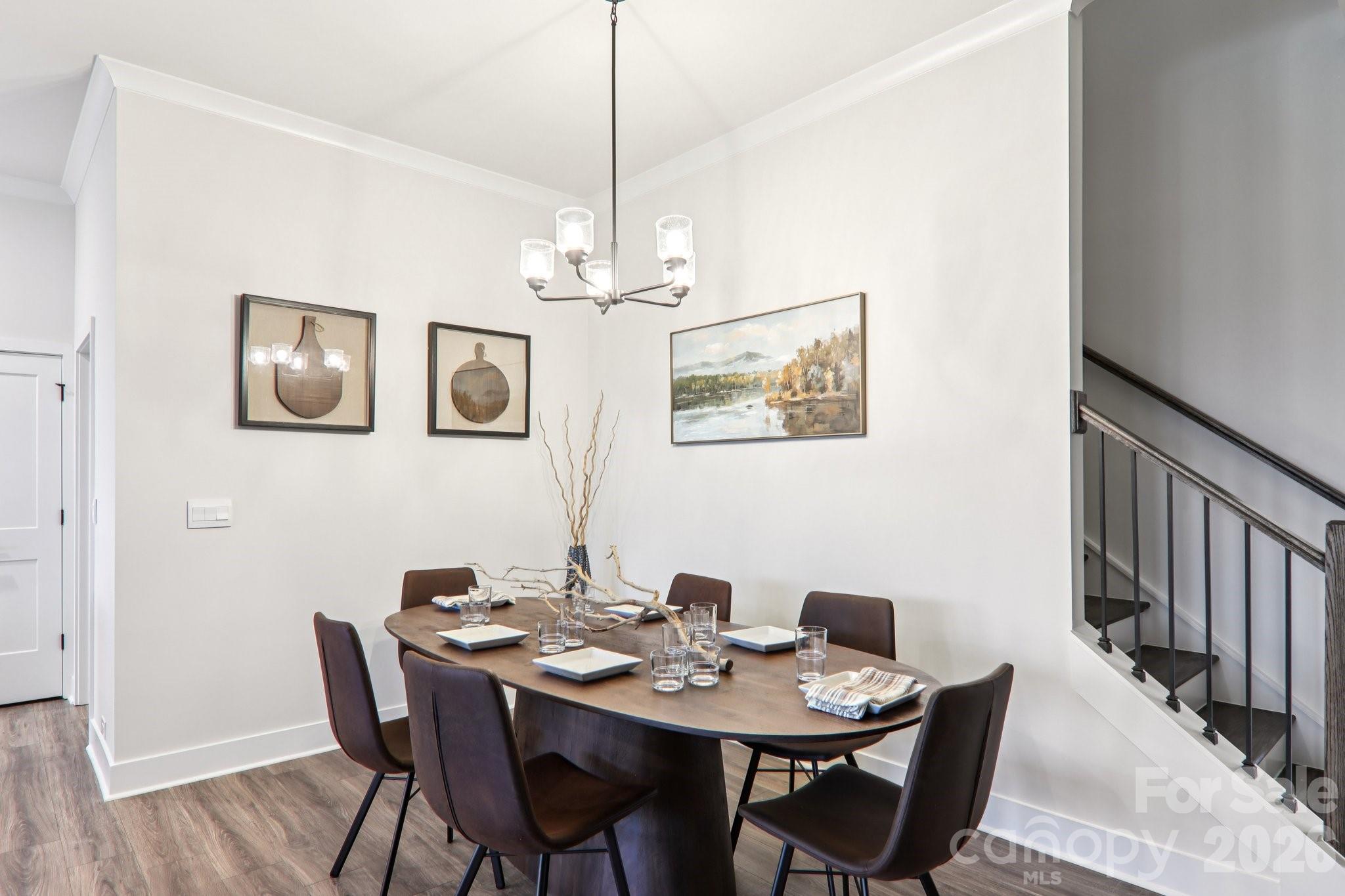 201 Piney Wds Road Fletcher, NC 28732 - Photo 6 of 47 a view of a dining room with furniture wooden floor and a chandelier