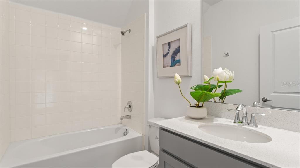 782 Rivington Avenue DeBary, FL 32713 - Photo 11 of 25 a bathroom with a granite countertop sink a toilet and shower