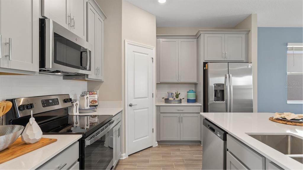 782 Rivington Avenue DeBary, FL 32713 - Photo 2 of 25 a kitchen with a sink stove and refrigerator