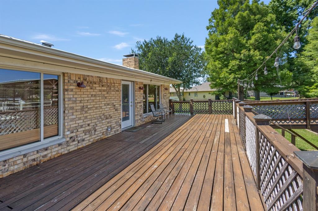 227 Scenic Road Trinidad, TX 75163 - Photo 25 of 40 a balcony with wooden floor and outdoor seating