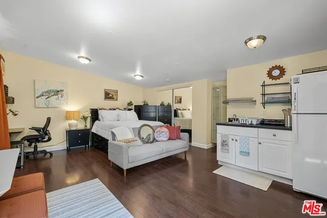 a bedroom with furniture and a wooden floor