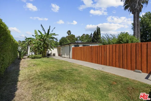 an aerial view of residential house with green space