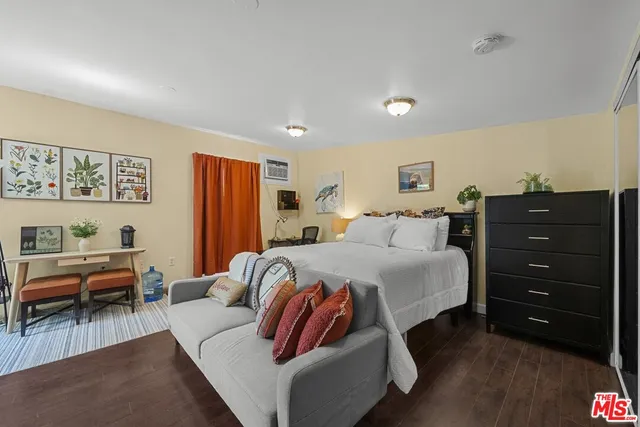 a spacious bedroom with a bed and a couch