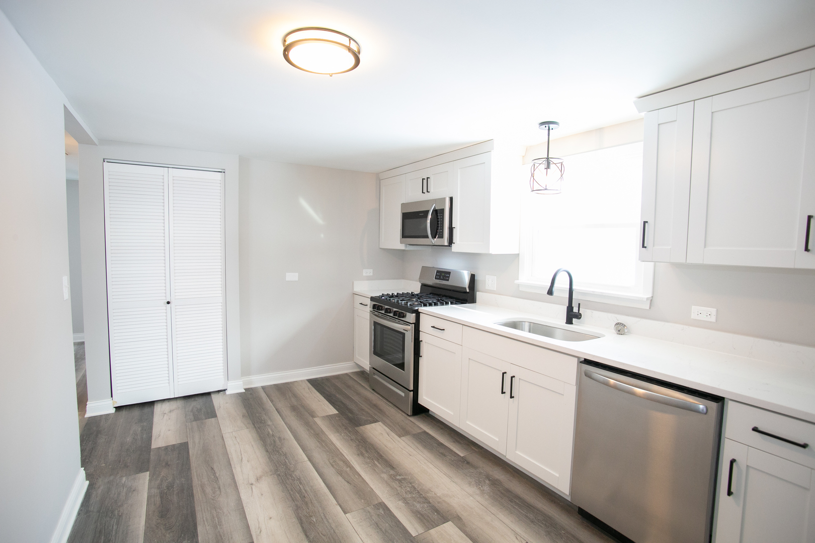 15039 Copter Lane Romeoville, IL 60446 - Photo 5 of 17 a kitchen with a sink stove and cabinets