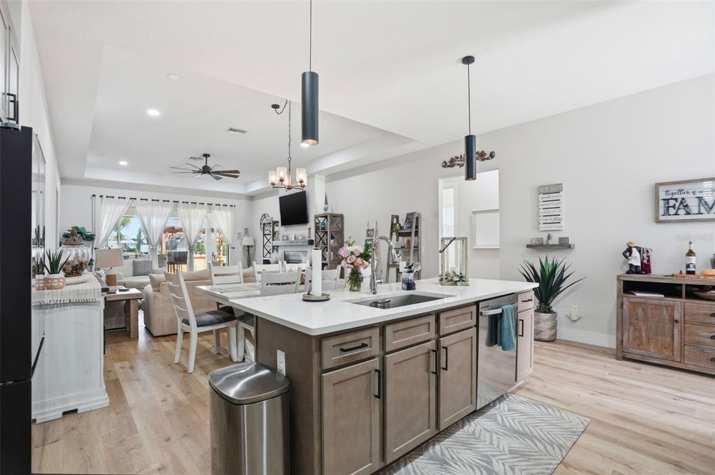 9013 Mississippi Run Weeki Wachee, FL 34613 - Photo 13 of 99 a view of a kitchen with kitchen island a sink stainless steel appliances and living room view