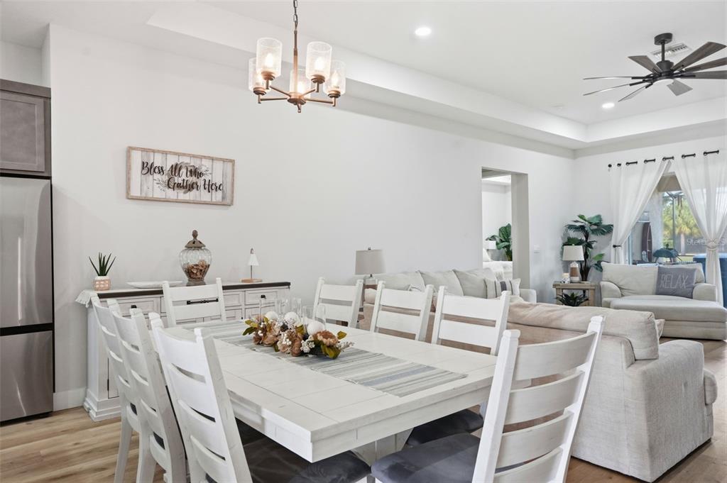 9013 Mississippi Run Weeki Wachee, FL 34613 - Photo 18 of 99 a view of a dining room with furniture and a chandelier
