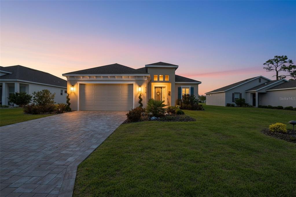 9013 Mississippi Run Weeki Wachee, FL 34613 - Photo 2 of 99 a front view of a house with a yard and garage