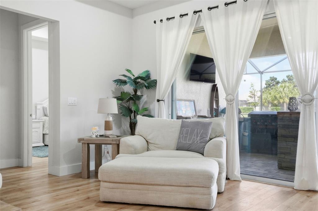 9013 Mississippi Run Weeki Wachee, FL 34613 - Photo 27 of 99 a living room with furniture a flat screen tv and a large window