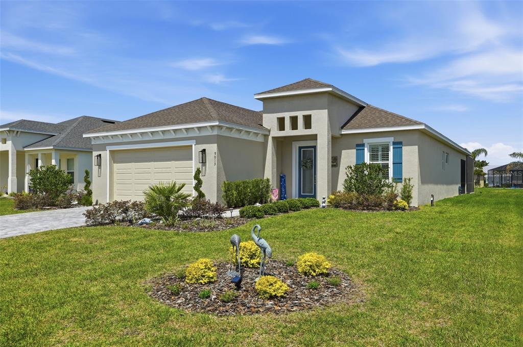 9013 Mississippi Run Weeki Wachee, FL 34613 - Photo 3 of 99 a front view of a house with a yard