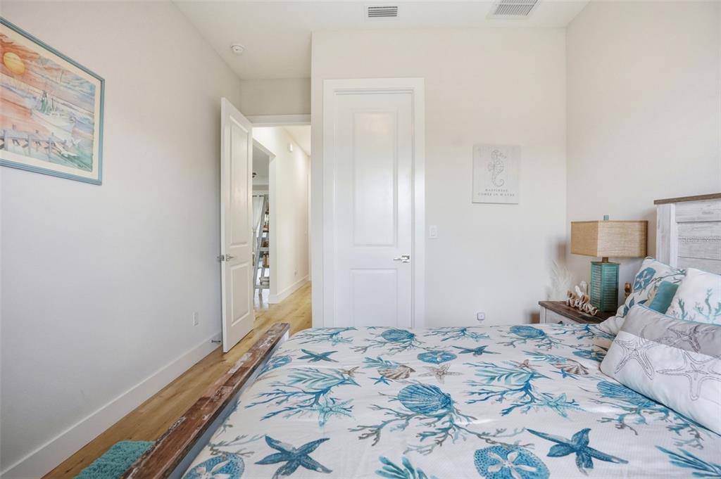 9013 Mississippi Run Weeki Wachee, FL 34613 - Photo 37 of 99 a bedroom with a bed and wooden floor