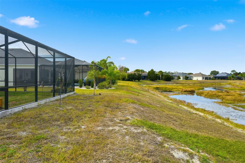 9013 Mississippi Run Weeki Wachee, FL 34613 - Photo 62 of 99 a view of a swimming pool with an outdoor seating and a garden