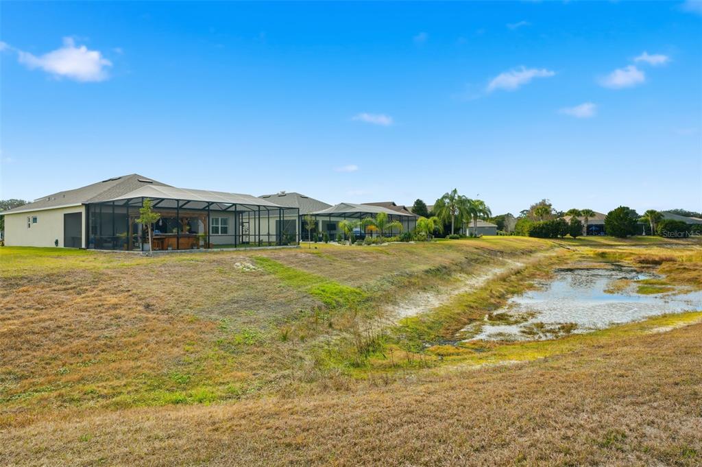 9013 Mississippi Run Weeki Wachee, FL 34613 - Photo 63 of 99 a view of a lake with a house in the background