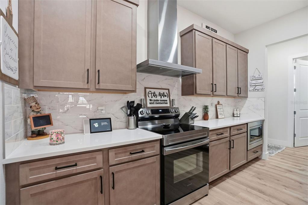 9013 Mississippi Run Weeki Wachee, FL 34613 - Photo 9 of 99 a kitchen with stainless steel appliances granite countertop a sink a stove and cabinets