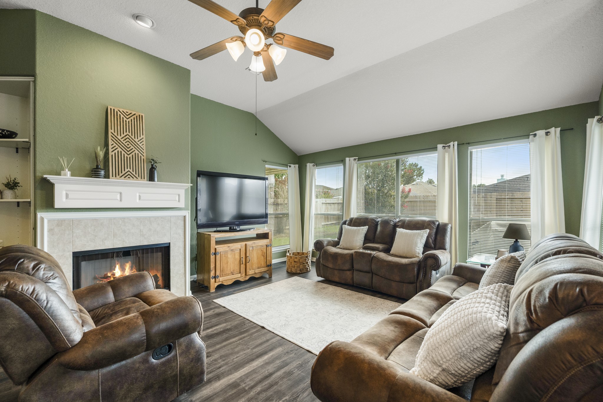 3422 Falcon Trail Court Spring, TX 77373 - Photo 6 of 35 a living room with furniture a flat screen tv and a fireplace