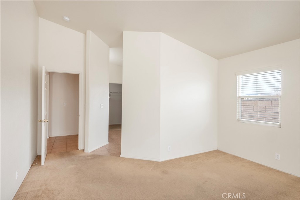 21189 Colombard Way Apple Valley, CA 92308 - Photo 16 of 48 a view of an empty room with a window