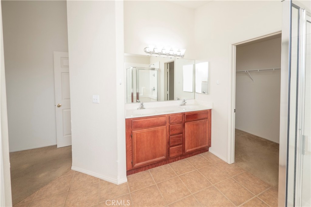 21189 Colombard Way Apple Valley, CA 92308 - Photo 17 of 48 a bathroom with a granite countertop sink and a mirror