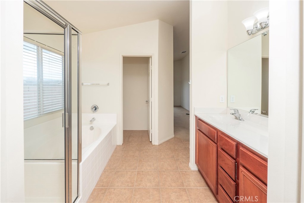 21189 Colombard Way Apple Valley, CA 92308 - Photo 18 of 48 a bathroom with a double vanity sink and mirror
