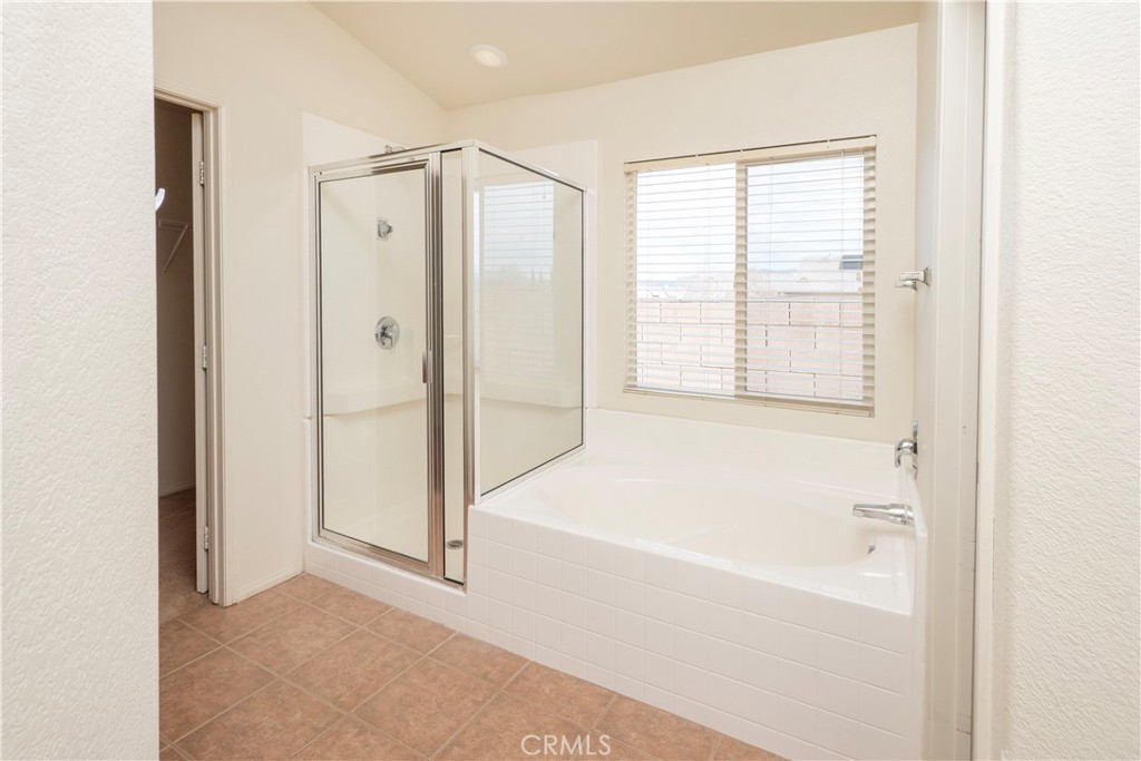21189 Colombard Way Apple Valley, CA 92308 - Photo 19 of 48 a bathroom with a bathtub and a shower