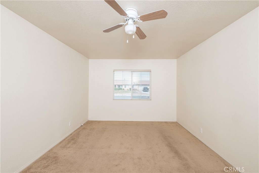 21189 Colombard Way Apple Valley, CA 92308 - Photo 23 of 48 an empty room with a window and a ceiling fan