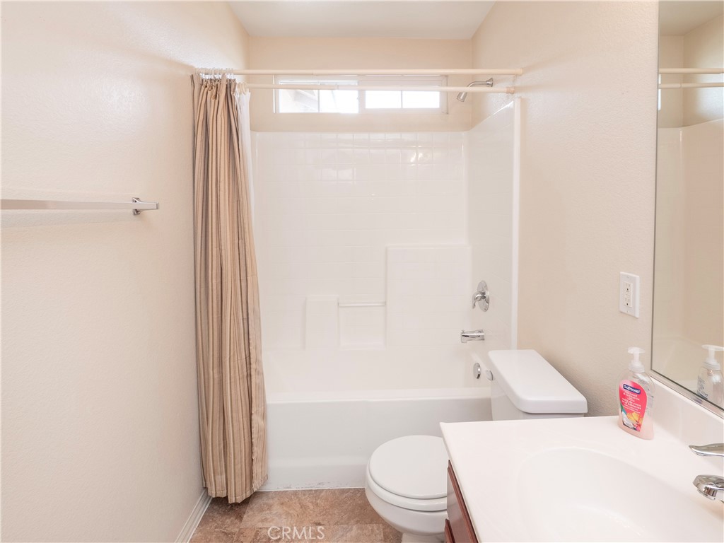 21189 Colombard Way Apple Valley, CA 92308 - Photo 27 of 48 a white toilet sitting next to a bathroom sink