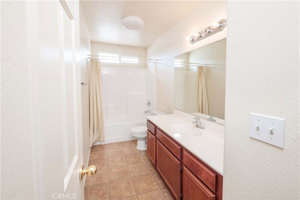 21189 Colombard Way Apple Valley, CA 92308 - Photo 30 of 48 a bathroom with a sink a toilet and shower